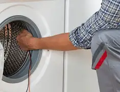 Dryer repair technician diagnosing and servicing a clothes dryer in Springfield, MO