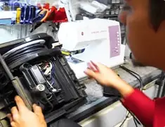 Vacuum repair technician servicing internal components on a workbench in Springfield, MO